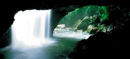 Water cascades into the Natural Bridge cave